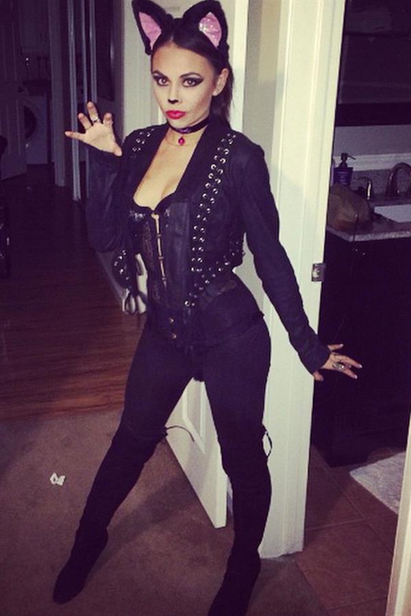 Janel Parrish as a black cat for Halloween