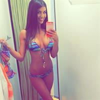 Carlie Jo in a bikini taking a selfie