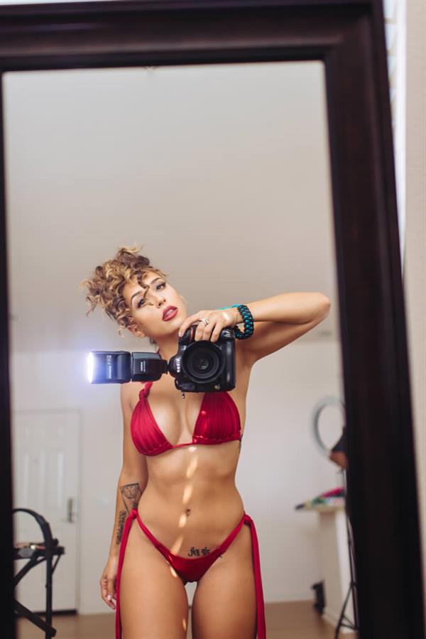 Tianna Gregory in a bikini taking a selfie