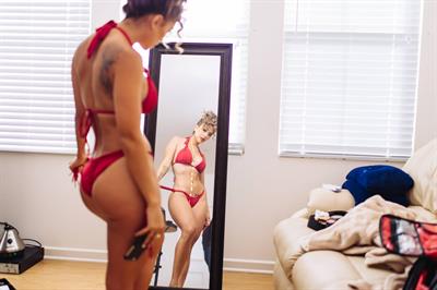 Tianna Gregory in a bikini taking a selfie