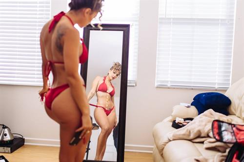 Tianna Gregory in a bikini taking a selfie