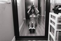 Tianna Gregory in a bikini taking a selfie