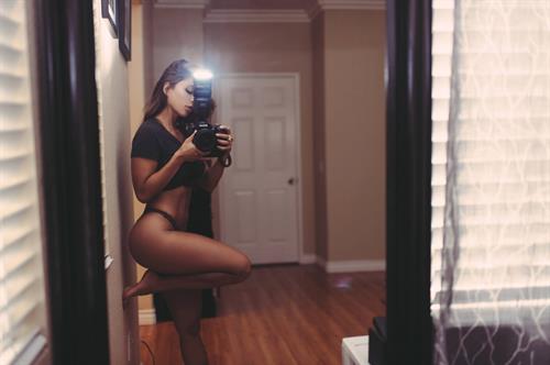 Tianna Gregory in a bikini taking a selfie