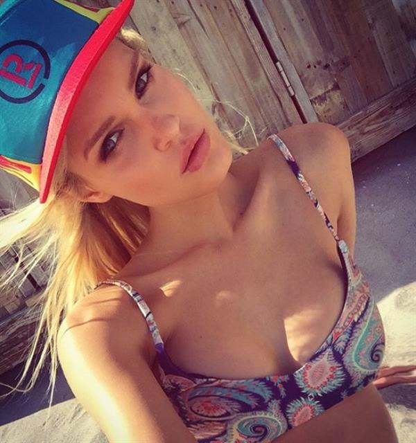 Joy Corrigan in a bikini taking a selfie