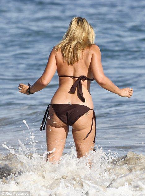 Natasha Henstridge in a bikini - ass