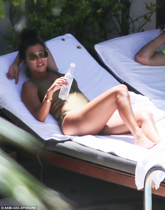 Kourtney Kardashian Bikini Pictures The curvy mom also immersed herself in the water before returning to her lounge to recline and relax once again.