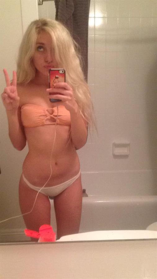 Naomi Woods in a bikini taking a selfie