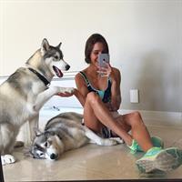 Kayla Itsines in a bikini taking a selfie