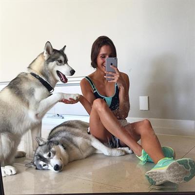 Kayla Itsines in a bikini taking a selfie