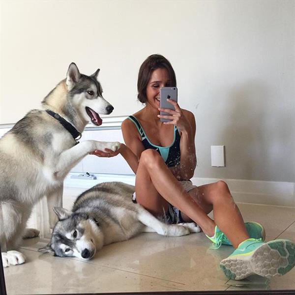 Kayla Itsines in a bikini taking a selfie