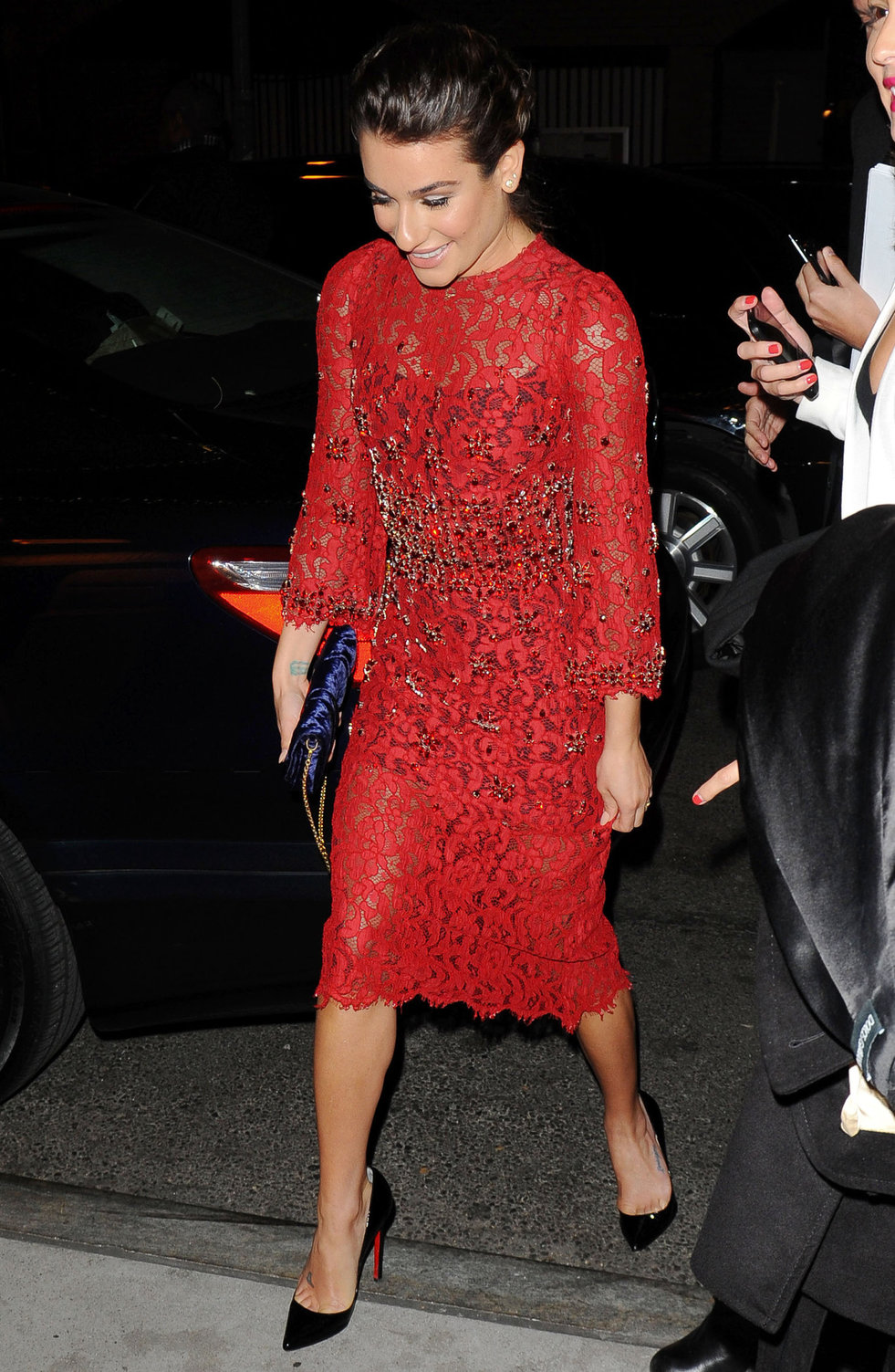 Lea Michele outside in a red dress at night