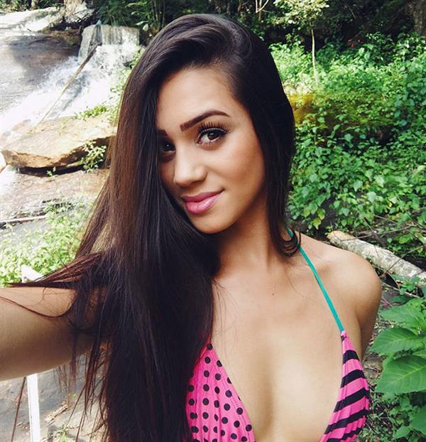 Bianca Rodrigues in a bikini taking a selfie