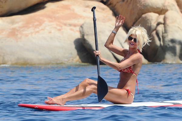Victoria Silvstedt wearing a bikini on a board in Sardinia on August 8, 2012