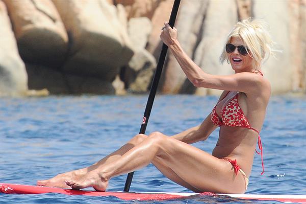 Victoria Silvstedt wearing a bikini on a board in Sardinia on August 8, 2012