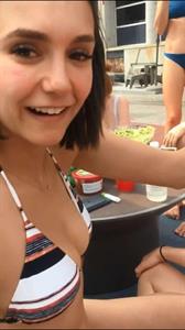 Nina Dobrev in a bikini taking a selfie