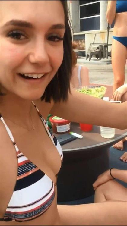 Nina Dobrev in a bikini taking a selfie