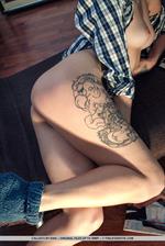 Callista flaunts her sexy, tattooed legs and delectable pussy on the floor.