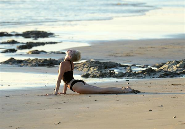 Miley Cyrus  yoga in black bikini on beach in Hawaii 1/24/13 