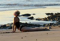 Miley Cyrus  yoga in black bikini on beach in Hawaii 1/24/13 