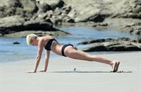 Miley Cyrus  yoga in black bikini on beach in Hawaii 1/24/13 