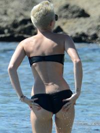 Miley Cyrus  yoga in black bikini on beach in Hawaii 1/24/13 