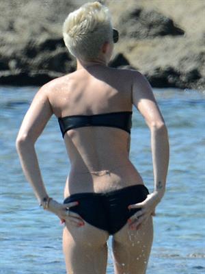 Miley Cyrus  yoga in black bikini on beach in Hawaii 1/24/13 