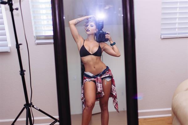 Tianna Gregory in a bikini taking a selfie