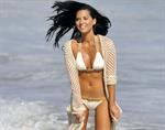 Olivia Munn on the beach in a white bikini