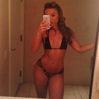 Nicole Mejia in a bikini taking a selfie