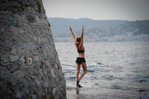 Kimberley Garner in a black bikini on the beach in St. Tropez on July 31, 2014