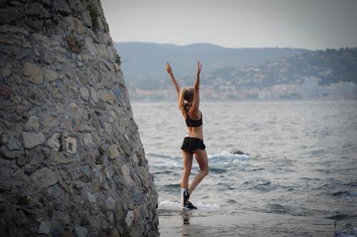 Kimberley Garner in a black bikini on the beach in St. Tropez on July 31, 2014