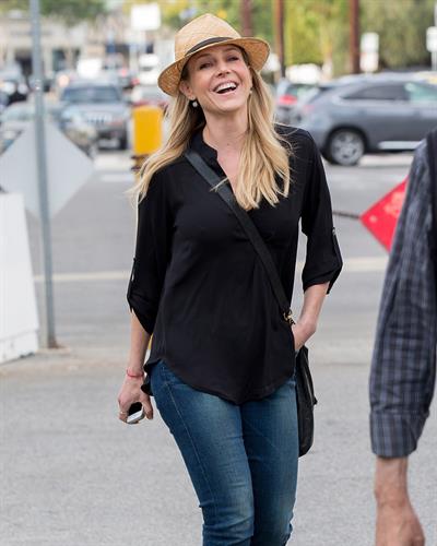 Julie Benz walking in jeans and a hat