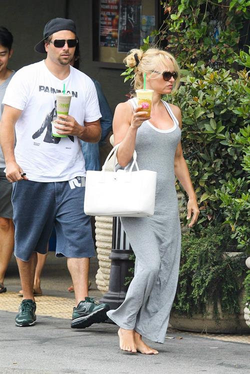 Pamela Anderson leaves barefoot a local Restaurant with a friend in Malibu July 6, 2013 