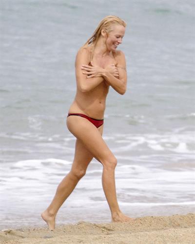Pamela Anderson Pamela Anderson Going topless at the beach in France 02.10.13
