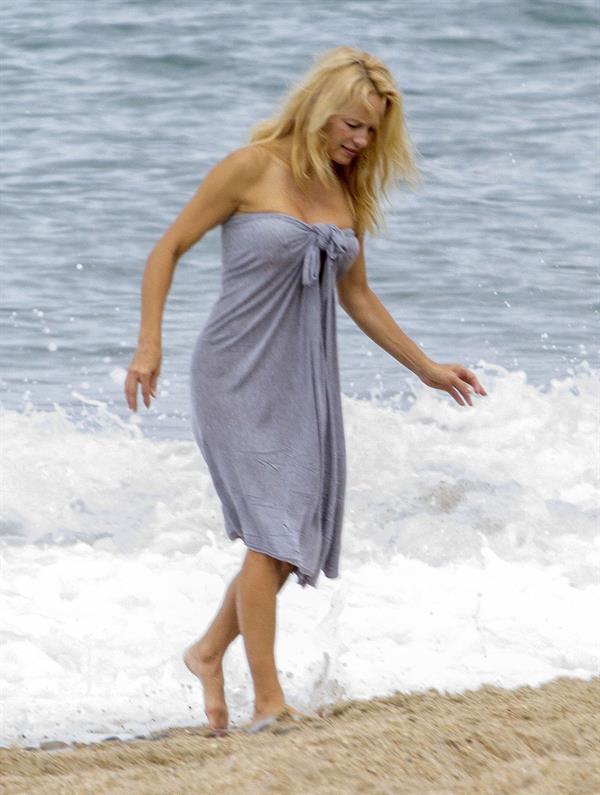 Pamela Anderson Pamela Anderson Going topless at the beach in France 02.10.13