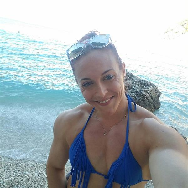 Katie M. Lee in a bikini taking a selfie