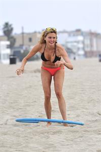 Estella Warren in a bikini with a hula hoop in Venice Beach on August 12, 2014