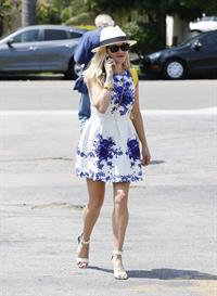 Reese Witherspoon talking and walking after leaving a hair salon in Beverly Hills on August 8, 2014