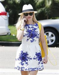 Reese Witherspoon talking and walking after leaving a hair salon in Beverly Hills on August 8, 2014