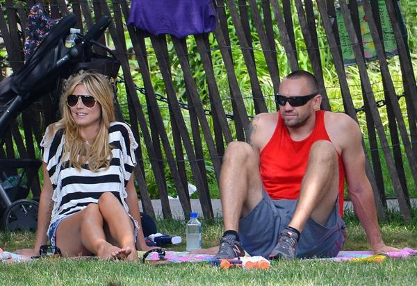 Heidi Klum in a black and white striped shirt, spends a day out in a park in Tribeca on June 30, 2013 