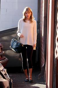 Taylor Swift wearing a white top and black pants in Los Angeles 10/28/13  
