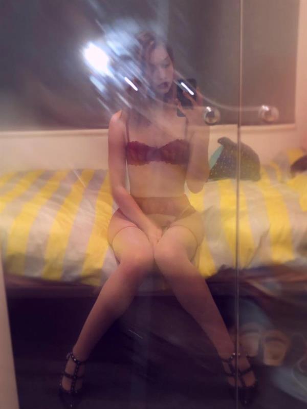 Jean Champion in lingerie taking a selfie