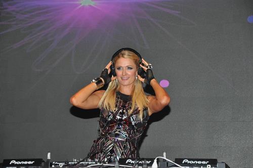 Paris Hilton walks for designer duo Shane and Falguni Peacock and performs as a DJ at the India Resort Fashion Week