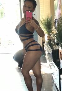 Siray Kong in a bikini taking a selfie