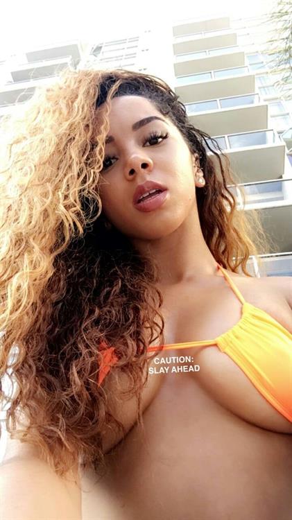Brittany Renner in a bikini taking a selfie