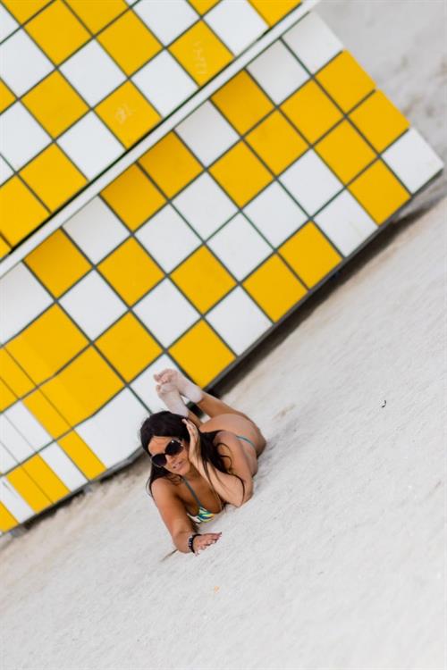 Claudia Romani Bikini Pictures Claudia Romani sexy doing yoga at the beach in a thong bikini showing off her boobs and ass seen by paparazzi.