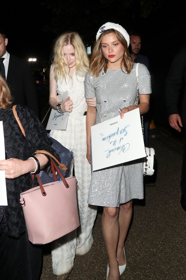 Ellie Bamber Pictures Ellie Bamber braless boobs while wearing basically a scarf as a top showing side boob cleavage.