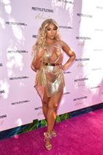 Ashanti sexy cleavage in a low cut dress at the PrettyLittleThings launch party.

