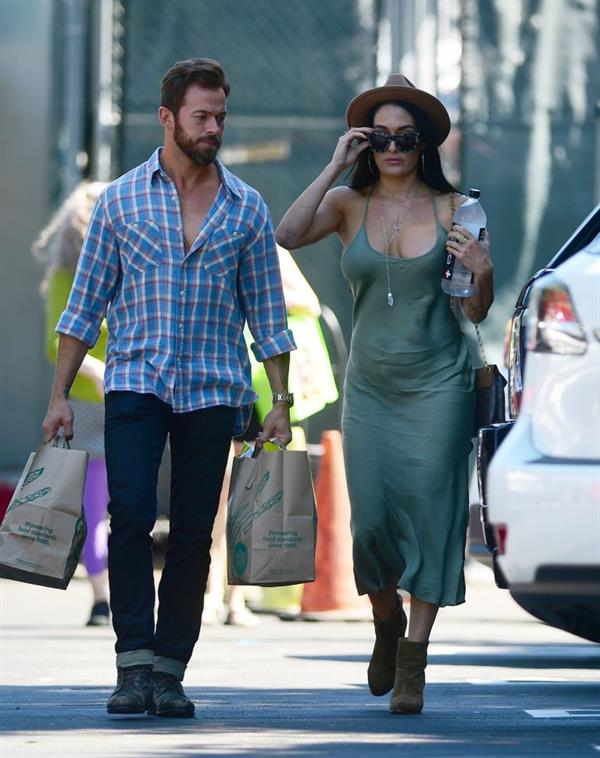 Nikki Bella braless boobs in a green dress seen by paparazzi.
















