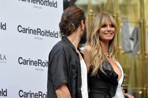 Heidi Klum Pictures Heidi Klum sexy braless cleavage showing her boobs in a black and white dress seen by paparazzi.